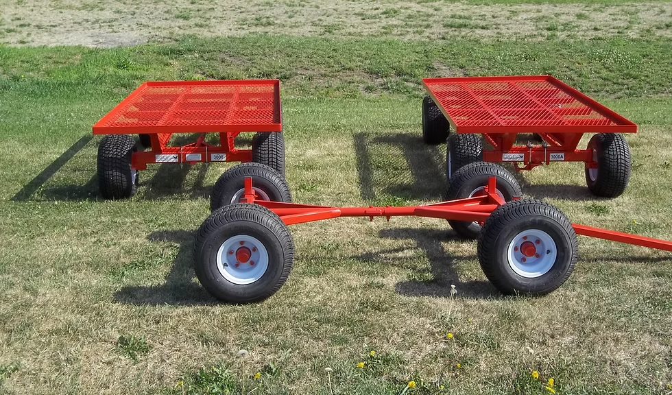 Two red Kory running gears with mesh decks parked on grass